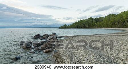 Stock Image - The rocky beach of Lake Winnipeg in Hecla-Grindstone Provincial Park; Riverton, Manitoba, Canada. Fotosearch