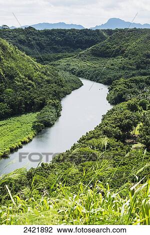 Stock Image - The Wailua River flows to the Pacific ocean; Kauai, Hawaii, United States of America. Fotosearch