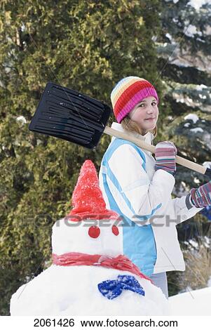 Thirteen Year Old Girl With Shovel Beside Snowmen, Winnipeg, Canada View Large Photo Image Stock Photograph - Thirteen Year Old Girl With Shovel Beside Snowmen, Winnipeg, Canada. Fotosearch