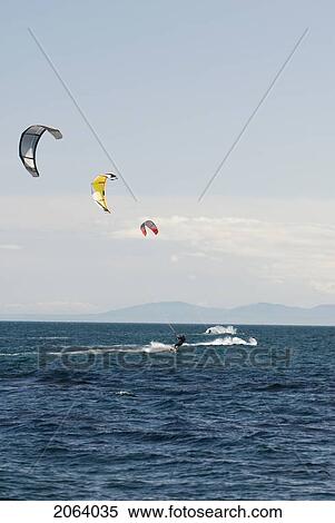 Three Kiteboarders On The Ocean With Colourful Kites, Victoria, Bc View Large Photo Image Stock Photography - Three Kiteboarders On The Ocean With Colourful Kites, Victoria, Bc. Fotosearch