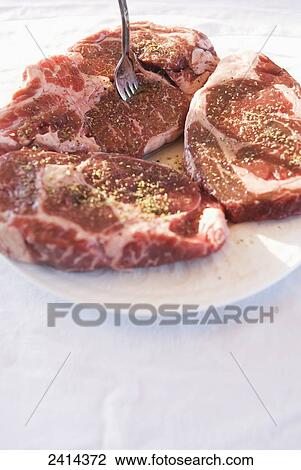 Three raw rib steaks ready to be grilled; Montreal, Quebec, Canada View Large Photo Image Stock Image - Three raw rib steaks ready to be grilled; Montreal, Quebec, Canada. Fotosearch
