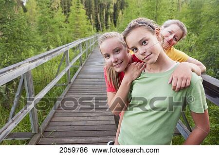Stock Photograph - Three Women Posed On Boardwalk Nature Trail, Riding Mountain National Park, Manitoba, Canada. Fotosearch
