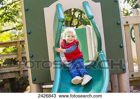 Toddler on a slide at the playground; Langley, British Columbia, Canada View Large Photo Image Stock Image - Toddler on a slide at the playground; Langley, British Columbia, Canada. Fotosearch