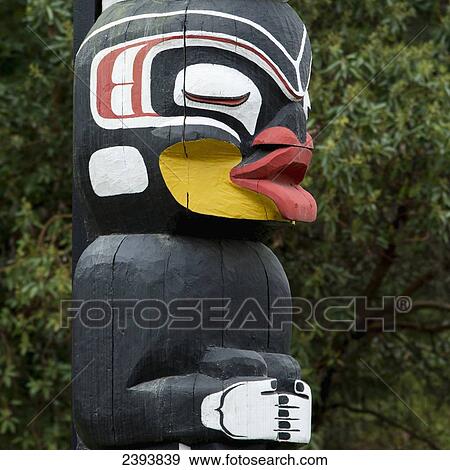 Stock Photo - Totem pole painted in colour; Vancouver, British Columbia, Canada. Fotosearch
