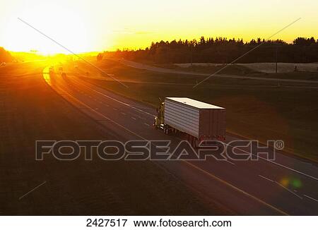 Truck heading down a highway at sunset; Edmonton, Alberta, Canada View Large Photo Image Stock Photo - Truck heading down a highway at sunset; Edmonton, Alberta, Canada. Fotosearch