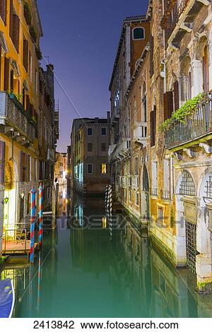 Turquoise water in a narrow canal between buildings at dusk; Venice, Veneto, Italy View Large Photo Image Stock Image - Turquoise water in a narrow canal between buildings at dusk; Venice, Veneto, Italy. Fotosearch