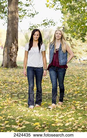 Two girlfriends walking in a park in autumn; Edmonton, Alberta, Canada View Large Photo Image Stock Photography - Two girlfriends walking in a park in autumn; Edmonton, Alberta, Canada. Fotosearch
