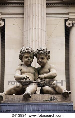 Two stone baby statues in front of building with stone column in the background; Frankfurt am Main, Germany View Large Photo Image Picture - Two stone baby statues in front of building with stone column in the background; Frankfurt am Main, Germany. Fotosearch