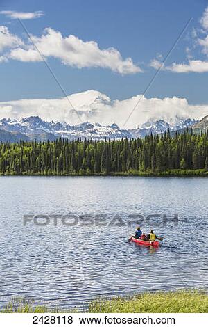 Two women and young girl in a red canoe on Byers lake with green forested shoreline and Mount McKinley peaking through the clouds, Denali State Park; Alaska, United States of America View Large Photo Image Stock Photo - Two women and young girl in a red canoe on Byers lake with green forested shoreline and Mount McKinley peaking through the clouds, Denali State Park; Alaska, United States of America. Fotosearch