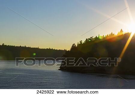 View from a BC Ferry destined for Swartz Bay, near Active Pass in Strait of Georgia at sunset; British Columbia, Canada View Large Photo Image Stock Image - View from a BC Ferry destined for Swartz Bay, near Active Pass in Strait of Georgia at sunset; British Columbia, Canada. Fotosearch