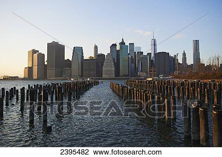 View of financial district of Manhattan from Brooklyn Bridge Park at sunset; New York City, New York, United States of America View Large Photo Image Stock Image - View of financial district of Manhattan from Brooklyn Bridge Park at sunset; New York City, New York, United States of America. Fotosearch