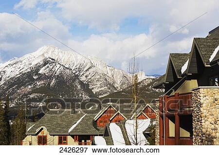 View of mountains over residential buildings; Canmore, Alberta, Canada View Large Photo Image Stock Photo - View of mountains over residential buildings; Canmore, Alberta, Canada. Fotosearch