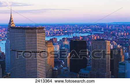 View of the Chrysler Building and Manhattan skyline from the Top of the Rock Observation Tower at the Rockefeller Center; New York City, New York, United States of America View Large Photo Image Picture - View of the Chrysler Building and Manhattan skyline from the Top of the Rock Observation Tower at the Rockefeller Center; New York City, New York, United States of America. Fotosearch