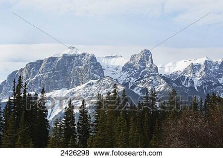 Stock Photo - View of the rocky mountains above the village of Canmore; Canmore, Alberta, Canada. Fotosearch