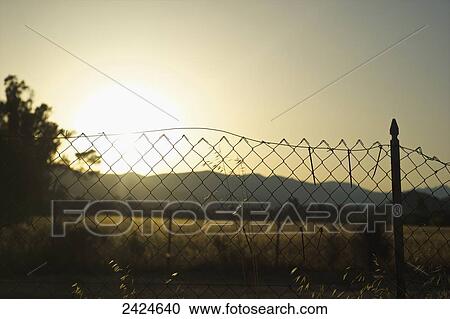 Stock Image - View of the sunset over the mountains; Sardinia, Italy. Fotosearch