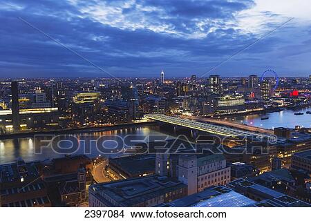 View over the River Thames, Tate Modern and London Eye Wheel at dusk; London, England View Large Photo Image Picture - View over the River Thames, Tate Modern and London Eye Wheel at dusk; London, England. Fotosearch