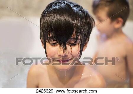 Water dripping down a young boy's face while having a bath with his brother in the background; Edmonton, Alberta, Canada View Large Photo Image Stock Photo - Water dripping down a young boy's face while having a bath with his brother in the background; Edmonton, Alberta, Canada. Fotosearch