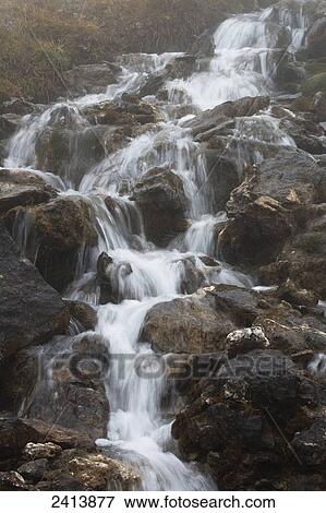 Stock Photo - Waterfalls flowing over a rocky mountainside; Lanserbach, Austria. Fotosearch