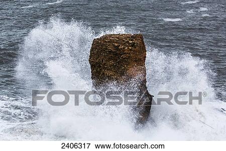 Stock Photo - Waves crashing against a rock formation; South Shields, Tyne and Wear, England. Fotosearch