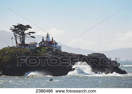 Waves of the pacific ocean crashing into the Oregon coast and a lighthouse; Oregon, United States of America View Large Photo Image Stock Photograph - Waves of the pacific ocean crashing into the Oregon coast and a lighthouse; Oregon, United States of America. Fotosearch