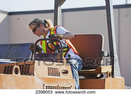 Woman driving stream roller repairing pot holes in parking lot; Edmonton, Alberta, Canada View Large Photo Image Stock Image - Woman driving stream roller repairing pot holes in parking lot; Edmonton, Alberta, Canada. Fotosearch