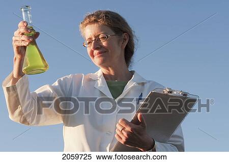Woman Holidng Flask Against Blue Sky, Manitoba, Canada View Large Photo Image Stock Photography - Woman Holidng Flask Against Blue Sky, Manitoba, Canada. Fotosearch