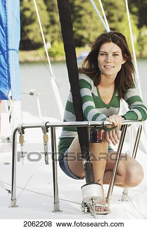 Woman Kneeling On Sailboat, Clear Lake, Riding Mountain National Park, Manitoba, Canada View Large Photo Image Stock Photo - Woman Kneeling On Sailboat, Clear Lake, Riding Mountain National Park, Manitoba, Canada. Fotosearch