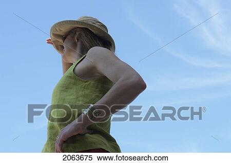Stock Photography - Woman Looking Out Over Lake; Canada, Manitoba, Riding Mountain National Park. Fotosearch