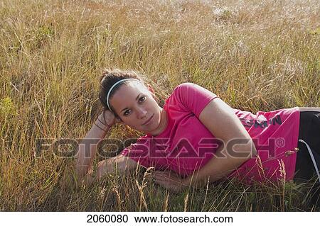 Woman Propped Up On Her Elbow On Hillside, Manitoba, Canada View Large Photo Image Stock Image - Woman Propped Up On Her Elbow On Hillside, Manitoba, Canada. Fotosearch