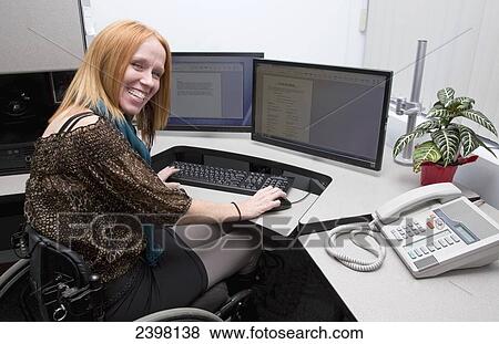 Woman with spinal cord injury working in a business setting; Edmonton, Alberta, Canada View Large Photo Image Stock Photo - Woman with spinal cord injury working in a business setting; Edmonton, Alberta, Canada. Fotosearch