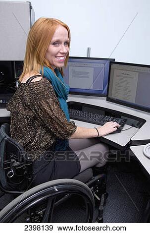 Woman with spinal cord injury working in a business setting; Edmonton, Alberta, Canada View Large Photo Image Stock Photo - Woman with spinal cord injury working in a business setting; Edmonton, Alberta, Canada. Fotosearch