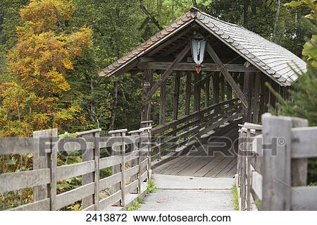 Wooden covered bridge with crucifix in the woods in autumn; Finkenburg, Austria View Large Photo Image Stock Image - Wooden covered bridge with crucifix in the woods in autumn; Finkenburg, Austria. Fotosearch