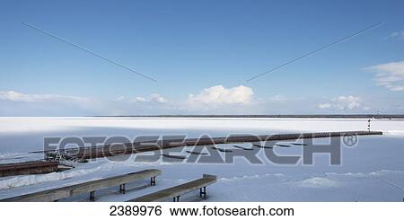 Wooden docks leading out to a frozen Lake Winnipeg covered with snow in Hecla-Grindstone Provincial Park in winter; Manitoba, Canada View Large Photo Image Stock Photograph - Wooden docks leading out to a frozen Lake Winnipeg covered with snow in Hecla-Grindstone Provincial Park in winter; Manitoba, Canada . Fotosearch