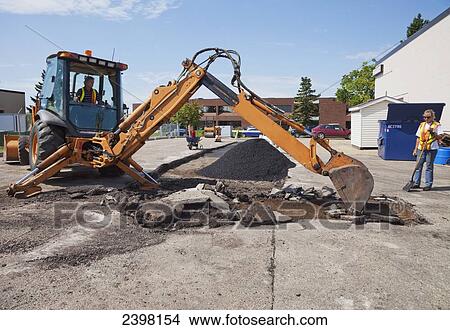 Work crew repairing pot holes in a parking lot; Edmonton, Alberta, Canada View Large Photo Image Picture - Work crew repairing pot holes in a parking lot; Edmonton, Alberta, Canada. Fotosearch