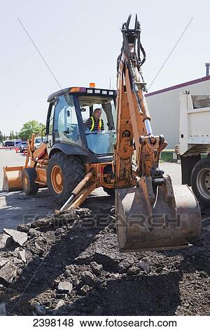 Work crew repairing pot holes in a parking lot; Edmonton, Alberta, Canada View Large Photo Image Stock Photo - Work crew repairing pot holes in a parking lot; Edmonton, Alberta, Canada. Fotosearch