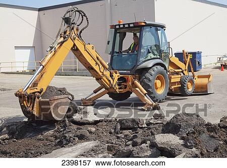 Stock Photo - Work crew repairing pot holes in a parking lot; Edmonton, Alberta, Canada. Fotosearch