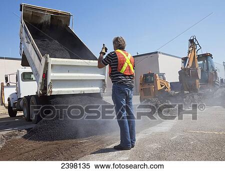 Work crew repairing pot holes in a parking lot; Edmonton, Alberta, Canada View Large Photo Image Stock Photography - Work crew repairing pot holes in a parking lot; Edmonton, Alberta, Canada. Fotosearch