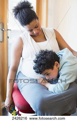 Young boy listening to his mother's pregnant belly at the end of her pregnancy; Toronto, Ontario, Canada View Large Photo Image Stock Photograph - Young boy listening to his mother's pregnant belly at the end of her pregnancy; Toronto, Ontario, Canada. Fotosearch