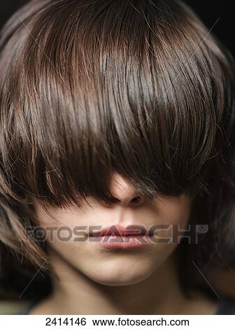 Young boy with long brunette hair covering his eyes View Large Photo Image Stock Photograph - Young boy with long brunette hair covering his eyes. Fotosearch