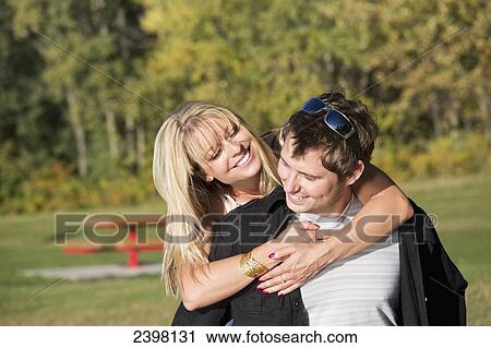 Young couple in a park; Edmonton, Alberta, Canada View Large Photo Image Stock Image - Young couple in a park; Edmonton, Alberta, Canada. Fotosearch