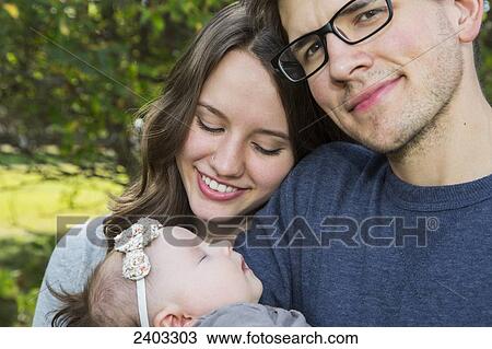 Young couple with infant daughter; Edmonton, Alberta, Canada View Large Photo Image Stock Image - Young couple with infant daughter; Edmonton, Alberta, Canada. Fotosearch
