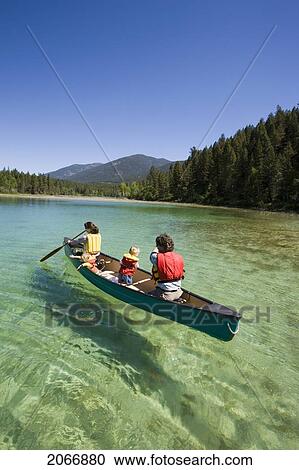 Young Family Canoeing On Loon Lake In The East Kootenays, British Columbia, Canada View Large Photo Image Stock Image - Young Family Canoeing On Loon Lake In The East Kootenays, British Columbia, Canada. Fotosearch