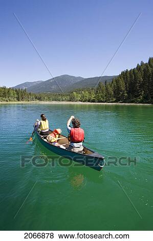 Young Family Canoeing On Loon Lake In The East Kootenays, British Columbia, Canada View Large Photo Image Stock Photo - Young Family Canoeing On Loon Lake In The East Kootenays, British Columbia, Canada. Fotosearch