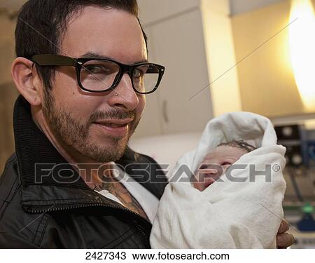 Young father holding his newborn daughter in a maternity ward; Edmonton, Alberta, Canada View Large Photo Image Stock Image - Young father holding his newborn daughter in a maternity ward; Edmonton, Alberta, Canada. Fotosearch