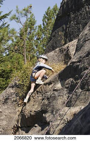 Young Girl (Age 7) Climbing On Granite Cliff At Stone Hills Near Rexford, Montana, Usa View Large Photo Image Stock Image - Young Girl (Age 7) Climbing On Granite Cliff At Stone Hills Near Rexford, Montana, Usa. Fotosearch