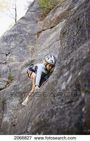 Young Girl (Age 7) Climbing On Granite Cliff At Stone Hills Near Rexford, Montana, Usa View Large Photo Image Stock Photo - Young Girl (Age 7) Climbing On Granite Cliff At Stone Hills Near Rexford, Montana, Usa. Fotosearch