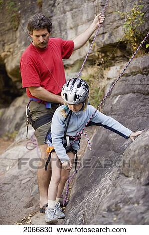 Young Girl (Age 7) Preparing To Climb While Father Belays At Stone Hills Near Rexford, Montana, Usa View Large Photo Image Stock Image - Young Girl (Age 7) Preparing To Climb While Father Belays At Stone Hills Near Rexford, Montana, Usa. Fotosearch