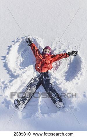 Young girl making a snow angel in wintertime; Talkeetna, Alaska, United States of America View Large Photo Image Stock Image - Young girl making a snow angel in wintertime; Talkeetna, Alaska, United States of America. Fotosearch