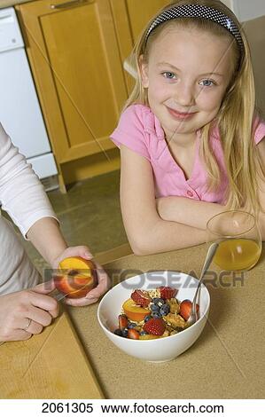 Stock Photography - Young Girl With Healthy Fruit And Cereal. Fotosearch