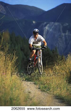Young Man Mountain Biking On Wigwam Flats Near Fernie, Bc, Canada View Large Photo Image Stock Photography - Young Man Mountain Biking On Wigwam Flats Near Fernie, Bc, Canada. Fotosearch